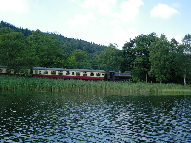 'A steam train on the preserved railway running to Lakeside on Windermere from Haverthwaite. This is taken from a rowing boat hired from the National Trust's Fell Foot Park.' (Words and photo © Copyright DS Pugh and licensed for reuse under this Creative Commons Licence, courtesy of www.geograph.org.uk/reuse.php?id=311504.)