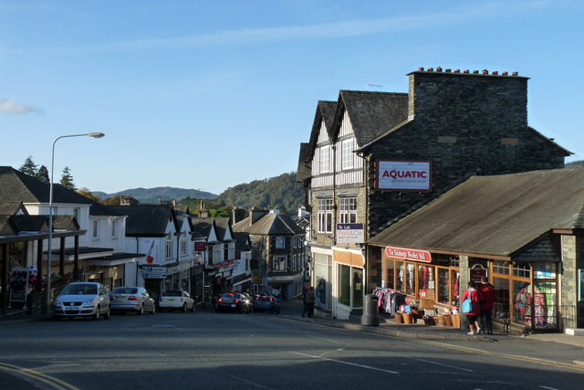 Crag Brow, a continuation of the main road, Lake Road, leads from Windermere into Bowness-on-Windermere. The road is crammed with shops, restaurants, a delicatessen, a bank, hair and beauty salons and other services. (Photo courtesy of www.geograph.org.uk/photo/1546571.)