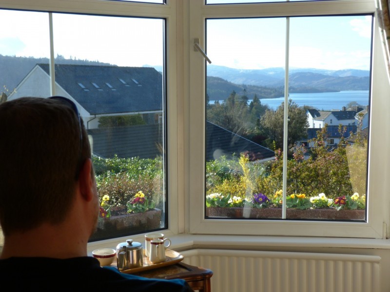 A guest relaxes with a pot of tea and admires sunny views from our lounge windows today.